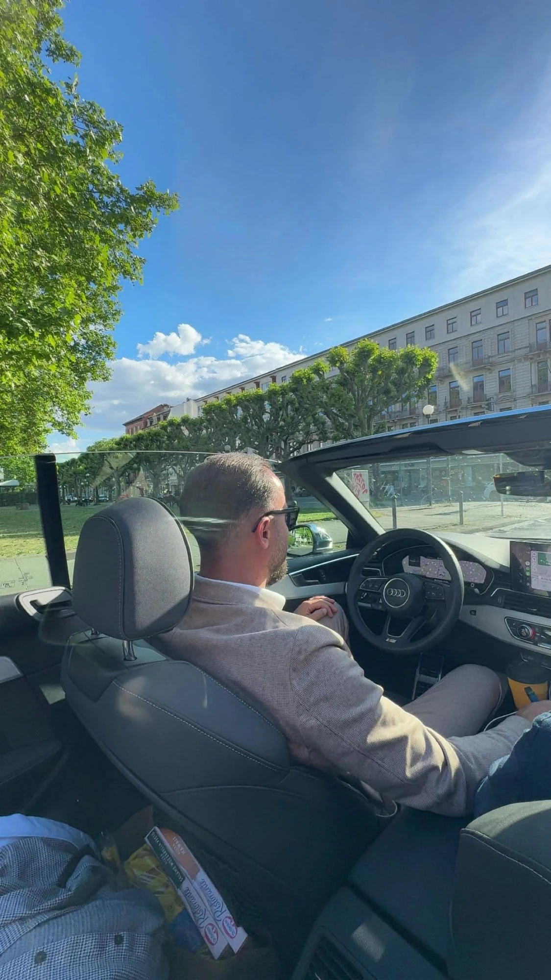 Unternehmer im offenen Cabrio an einem sonnigen Tag
